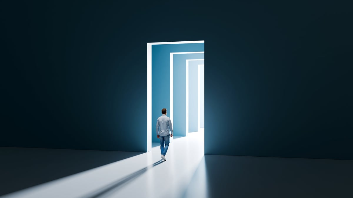 Man walking through glowing doorways
